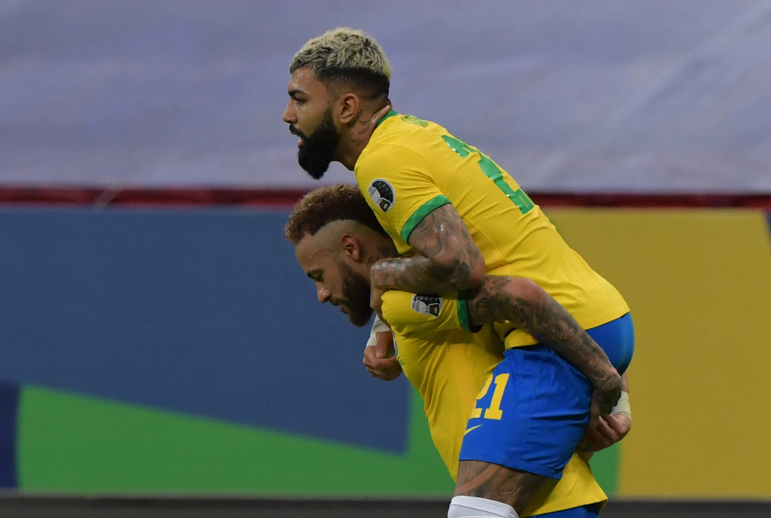 Brazil's Gabriel Barbosa (R) celebrates with teammate Neymar after scoring against Venezuela during the Conmebol Copa America 2021 football tournament group phase match at the Mane Garrincha Stadium in Brasilia on June 13, 2021. (Photo by NELSON ALMEIDA / AFP) (Photo by NELSON ALMEIDA/AFP via Getty Images)